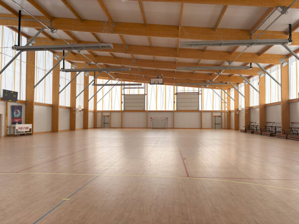 Construction d'un gymnase à Sénas. Un bâtiment durable en bois, dédié à la pratique du basket et du handball.